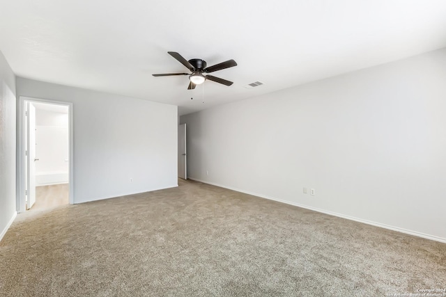 carpeted spare room with ceiling fan