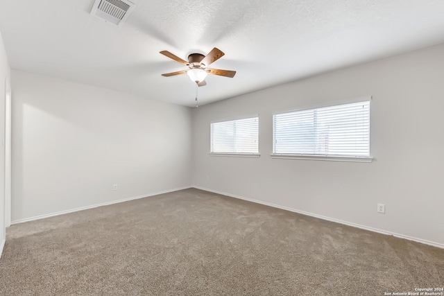 spare room featuring carpet flooring and ceiling fan