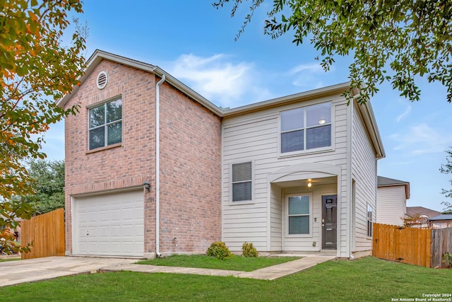 view of property with a garage and a front lawn