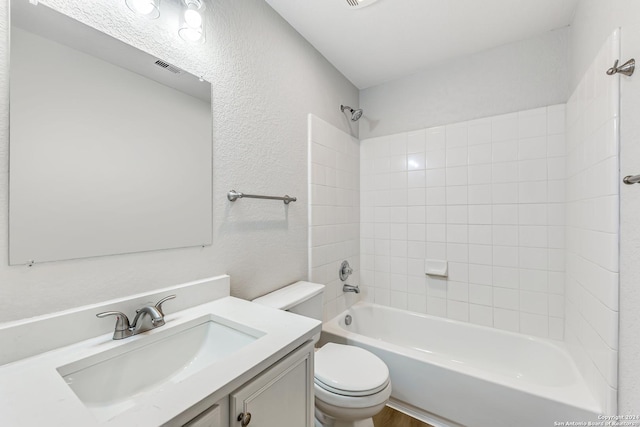 full bathroom with vanity, toilet, and tiled shower / bath