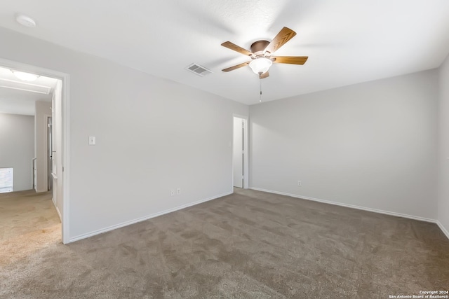 carpeted spare room with ceiling fan