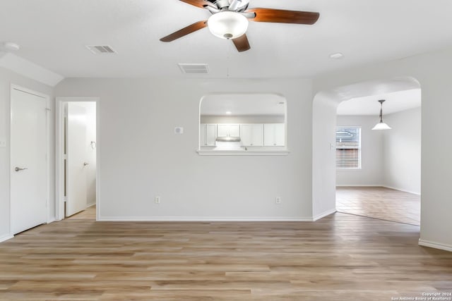 unfurnished living room with vaulted ceiling, light hardwood / wood-style flooring, and ceiling fan