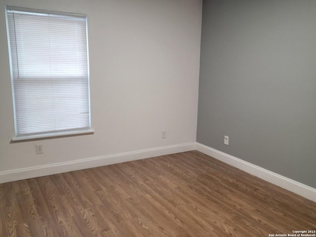 unfurnished room featuring dark hardwood / wood-style floors