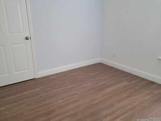 spare room with dark hardwood / wood-style floors