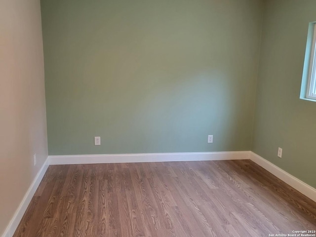 unfurnished room with light wood-type flooring