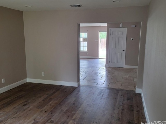 spare room featuring dark hardwood / wood-style flooring