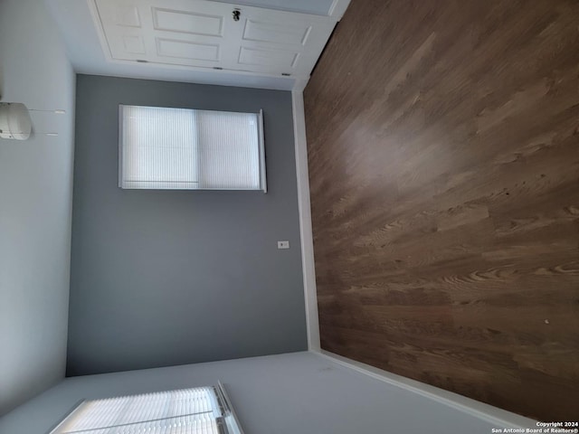 spare room featuring wooden walls