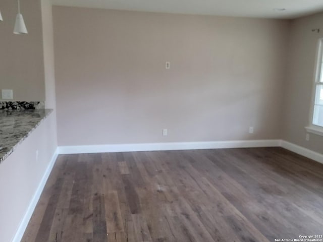 spare room featuring dark hardwood / wood-style flooring