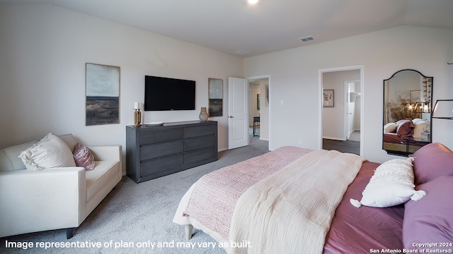 carpeted bedroom with ensuite bathroom and lofted ceiling