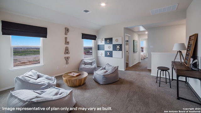 carpeted living room featuring lofted ceiling