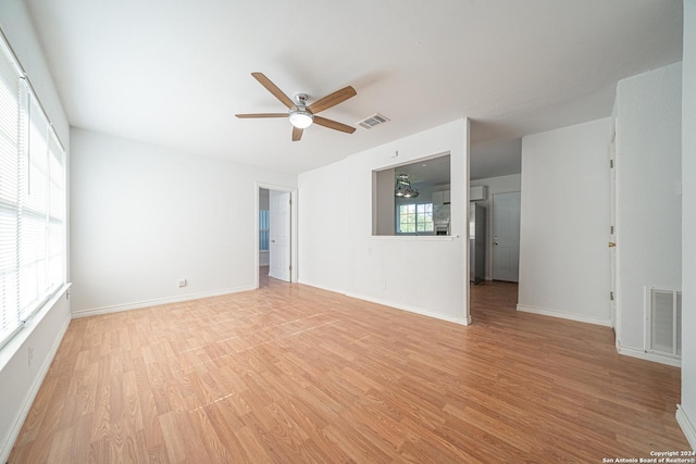 spare room with ceiling fan and light wood-type flooring