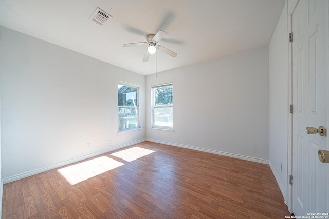 empty room with ceiling fan and wood-type flooring