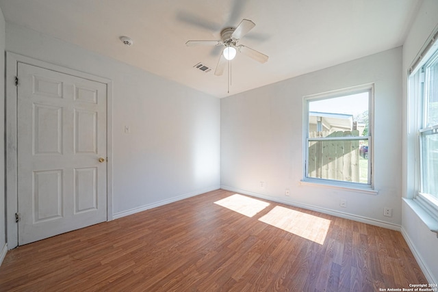 spare room with hardwood / wood-style floors and ceiling fan