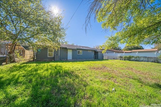 back of house with a lawn