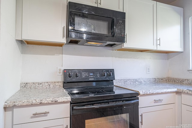 kitchen featuring white cabinets and black appliances