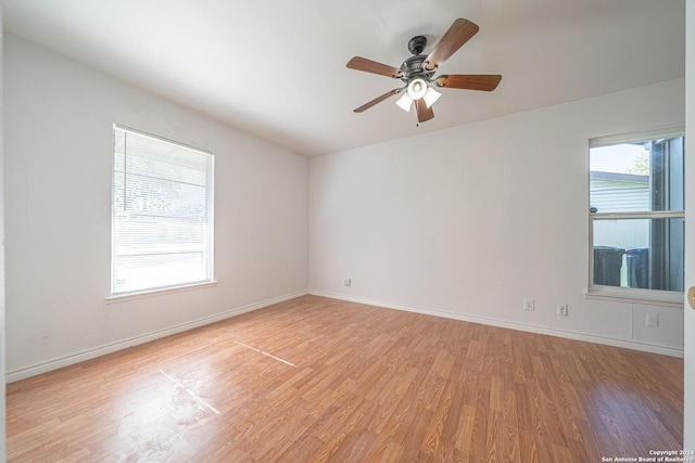 empty room featuring ceiling fan and light hardwood / wood-style floors