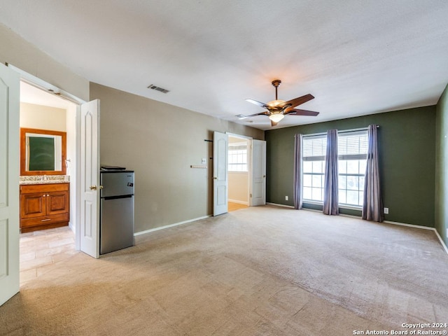 unfurnished room with ceiling fan and light colored carpet