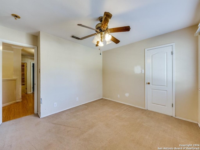 empty room with light carpet and ceiling fan