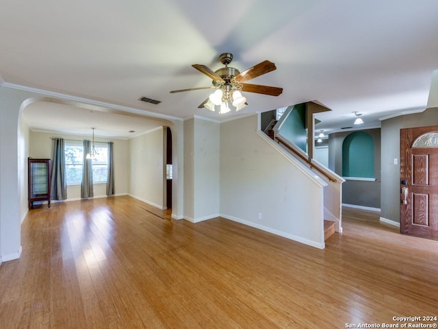 unfurnished living room with light wood-type flooring, ceiling fan, and ornamental molding