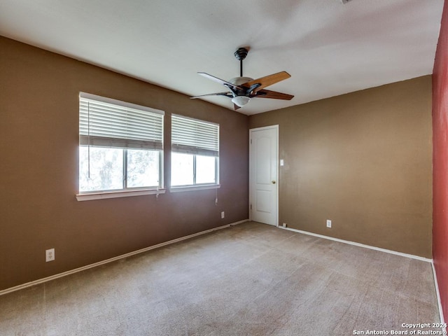 carpeted empty room with ceiling fan