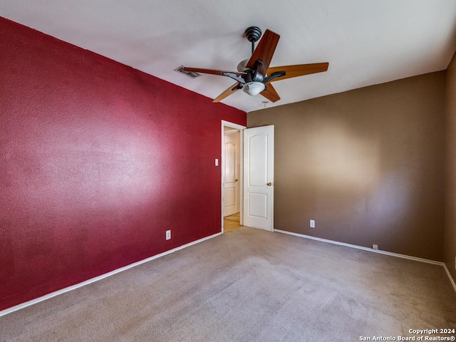 spare room featuring ceiling fan and light colored carpet