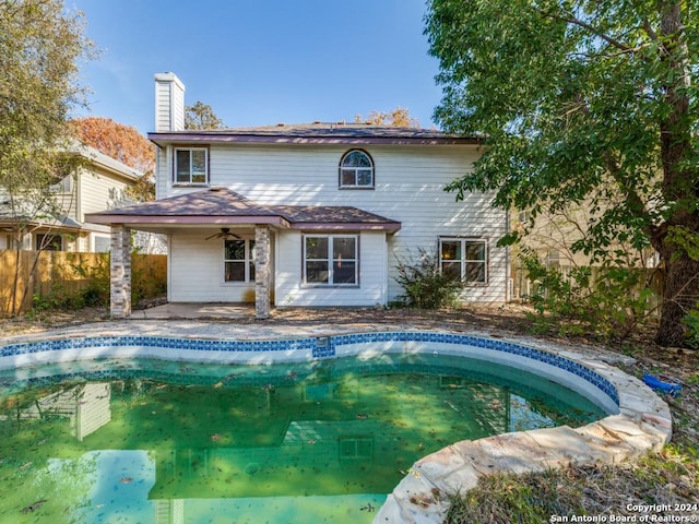 back of property with ceiling fan