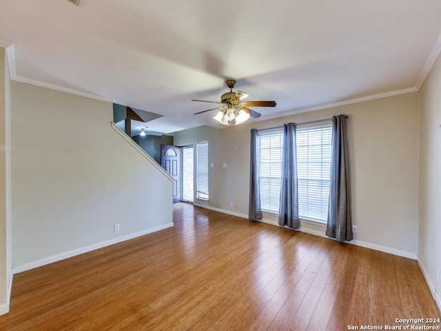 unfurnished room with hardwood / wood-style floors, ceiling fan, and crown molding