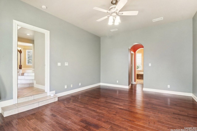 empty room featuring ceiling fan and dark wood-type flooring