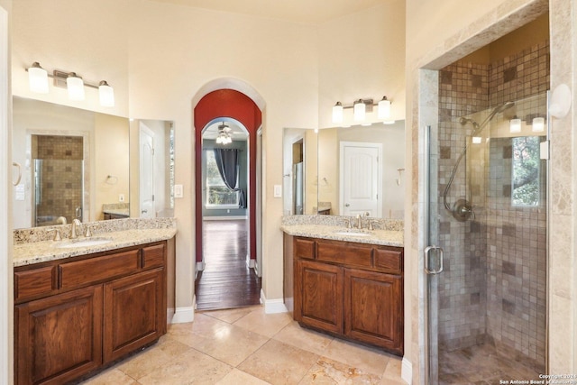 bathroom featuring an enclosed shower, vanity, plenty of natural light, and ceiling fan