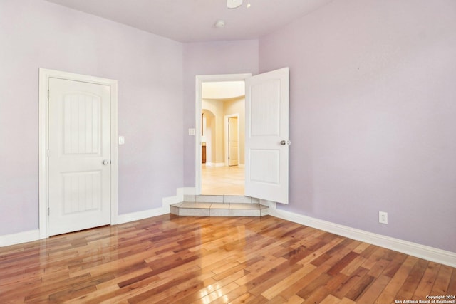 spare room with light hardwood / wood-style flooring