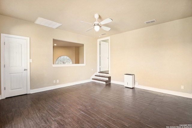 spare room featuring ceiling fan and dark hardwood / wood-style flooring