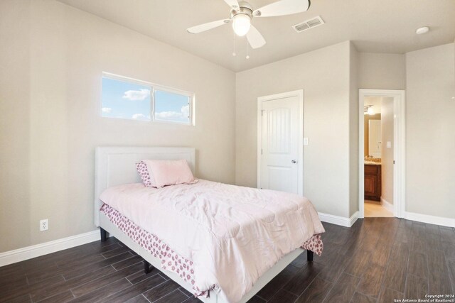 bedroom featuring ensuite bath, ceiling fan, and dark wood-type flooring