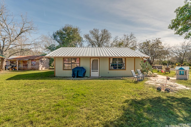 rear view of house with a yard