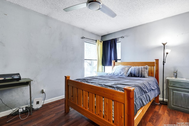 bedroom with ceiling fan, dark hardwood / wood-style flooring, and a textured ceiling