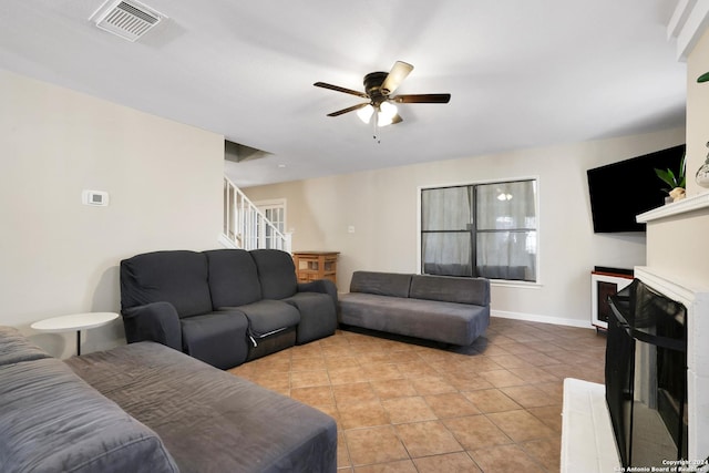 living room with ceiling fan and light tile patterned floors