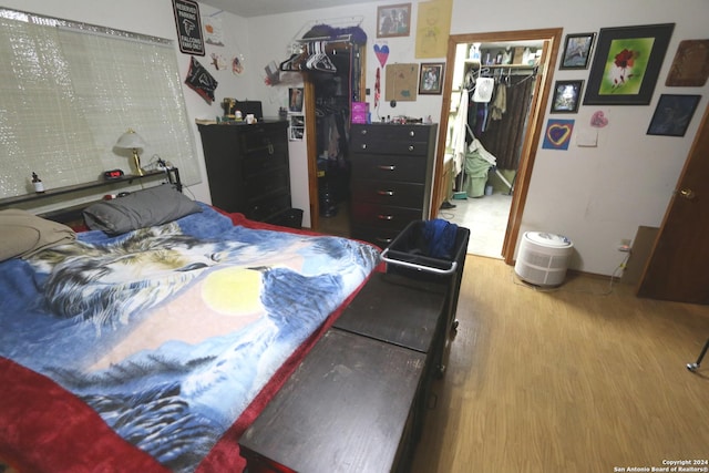 bedroom featuring hardwood / wood-style flooring and a closet