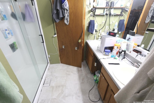 bathroom featuring vanity and an enclosed shower