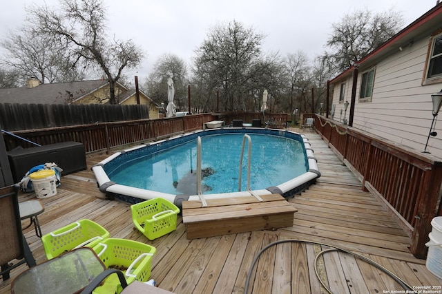 view of swimming pool with a wooden deck