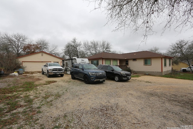 view of front of property featuring a garage and an outdoor structure