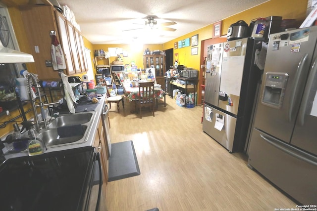 kitchen with sink, light hardwood / wood-style flooring, ceiling fan, a textured ceiling, and appliances with stainless steel finishes