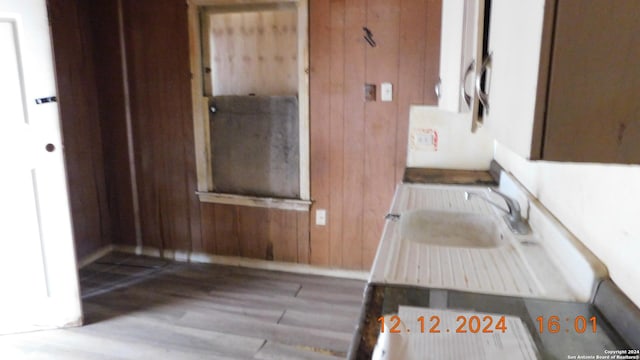 bathroom with wood walls and hardwood / wood-style flooring