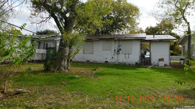 rear view of property featuring a yard