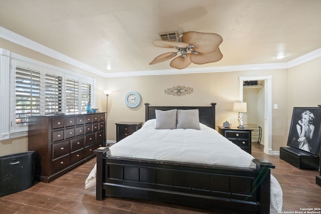 bedroom featuring ceiling fan, dark hardwood / wood-style flooring, and crown molding