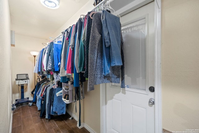 spacious closet featuring dark hardwood / wood-style flooring