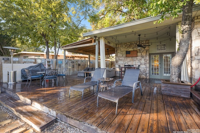 deck with french doors and ceiling fan