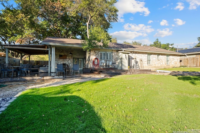 back of house featuring a patio area and a yard