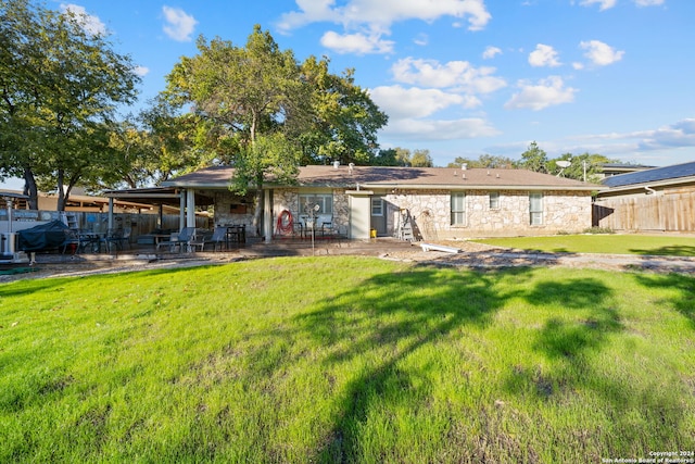 back of property featuring a yard and a patio area