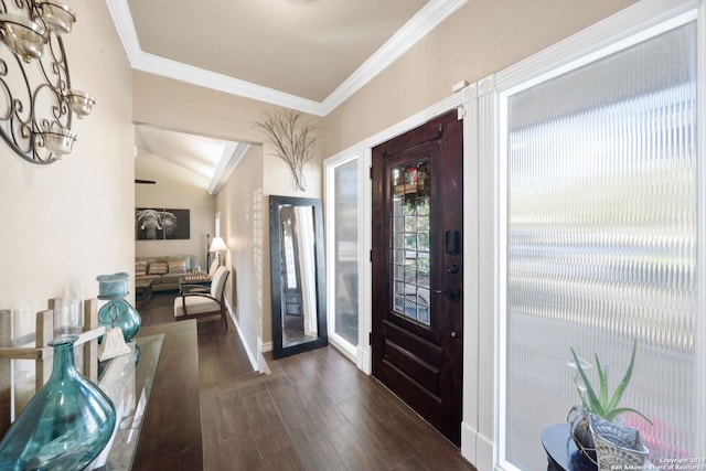 foyer with dark hardwood / wood-style flooring, ornamental molding, and vaulted ceiling