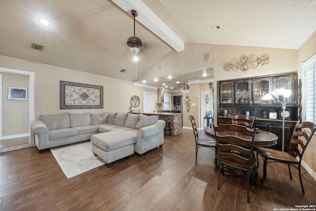 living room featuring lofted ceiling with beams and dark wood-type flooring