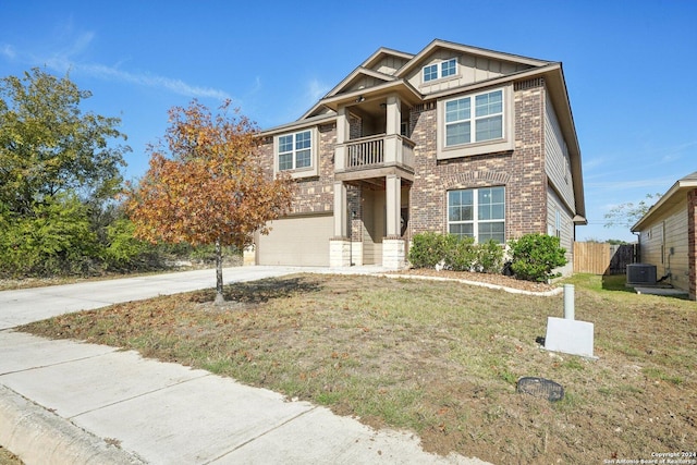 craftsman-style house with central AC unit, a garage, a balcony, and a front yard